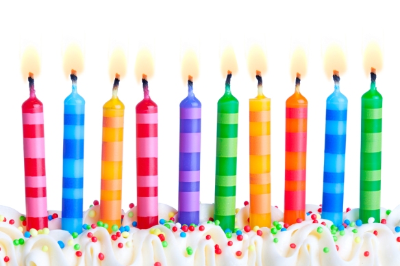 Ten birthday cake candles against a white background